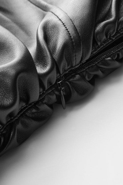 Close-up of a textured fabric surface with a zipper on a light background
