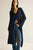 Woman wearing a long navy cardigan over a blue top with jeans on a white background
