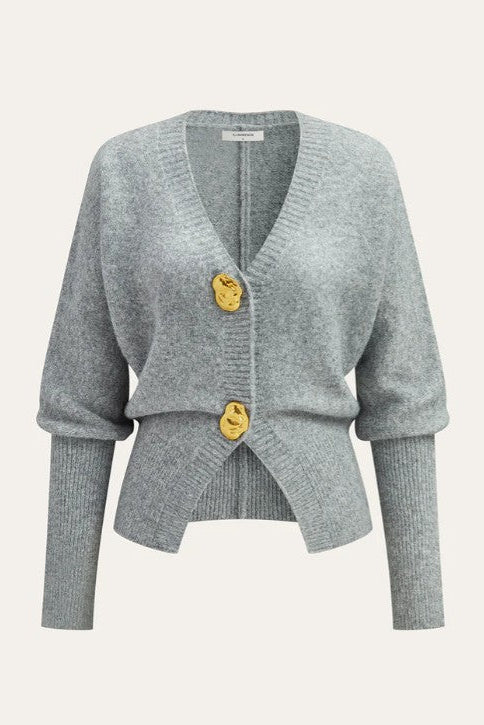 Gray cardigan with gold buttons on a light gray background