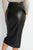 Black leather skirt worn by a person on a white background