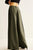 Green wide-leg pants worn by a person on a light background