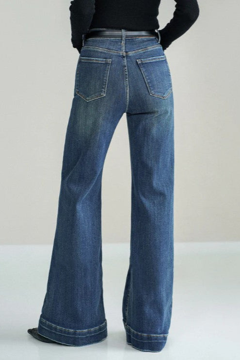 Blue jeans worn by a person on a white background